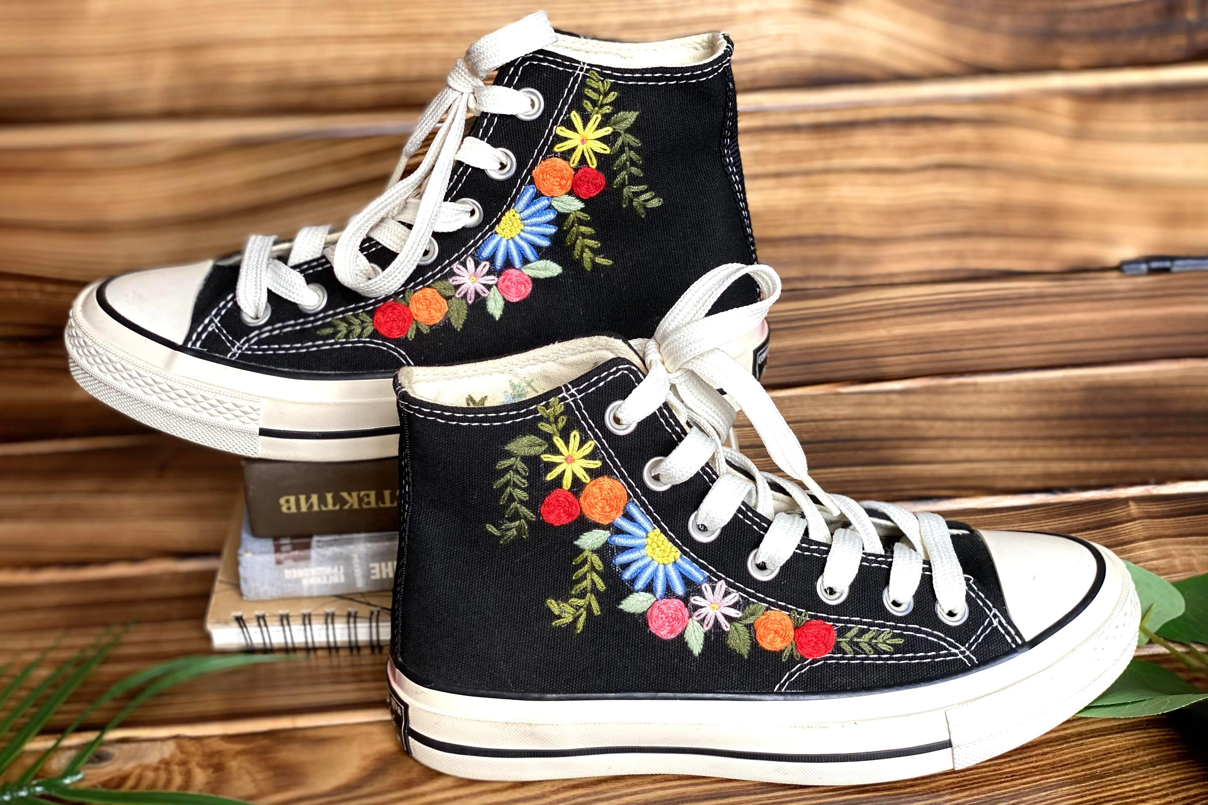 Converse High Tops shoes are embroidered with colorful flowers